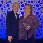 Woman holding award