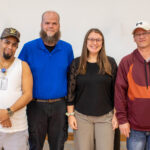 Four people posing together
