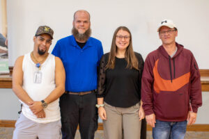 Four people posing together